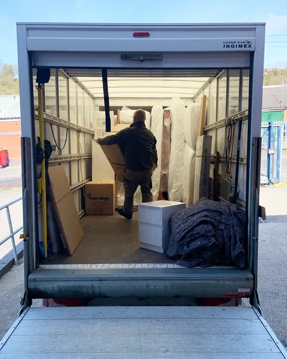 Back of a Green4Logistics removal van on a house move in Congleton town centre, Cheshire
