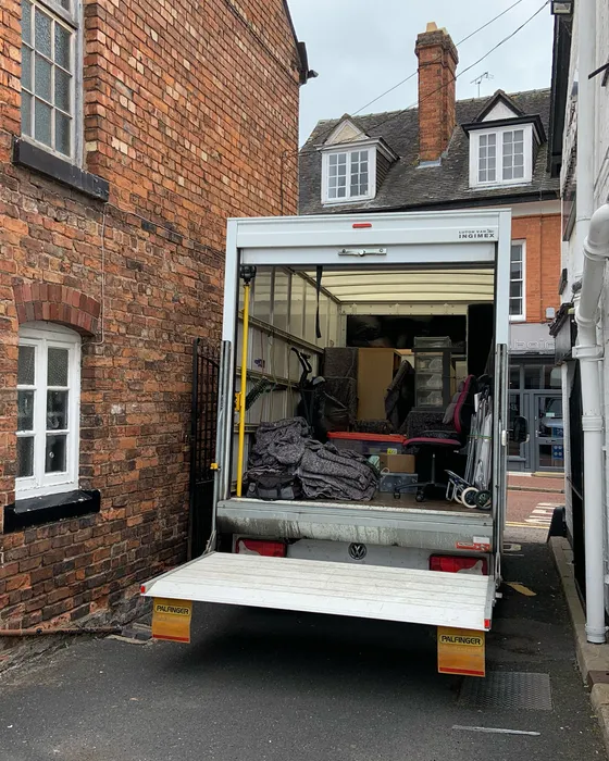 Back of a Green4Logistics removal van on a house move in Nantwich town centre, Cheshire