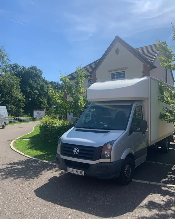 Back of a Green4Logistics removal van on a house move in Crewe town centre, Cheshire